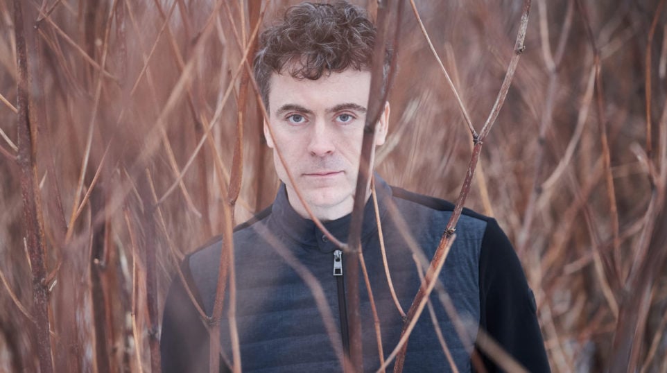 Paul Lewis standing in a field barren field