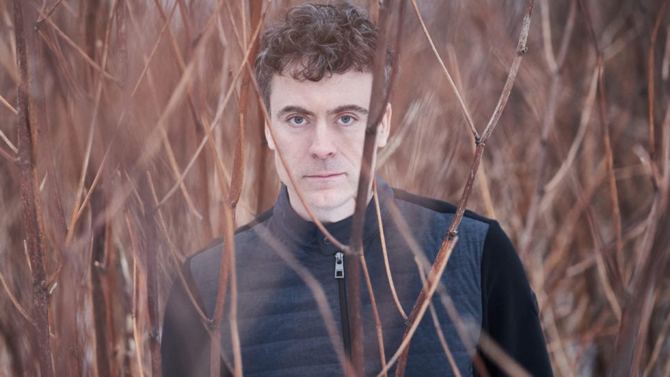 Paul Lewis standing in a field barren field