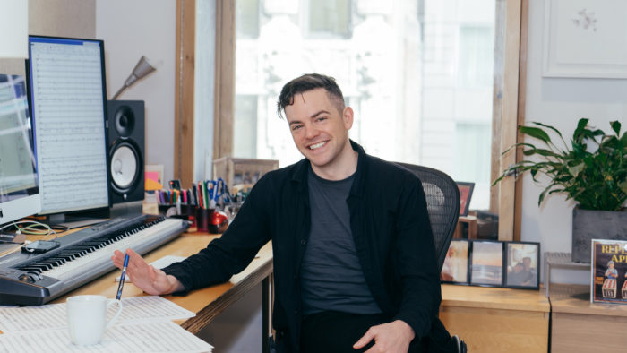 Nico Muhly smiles at work composing