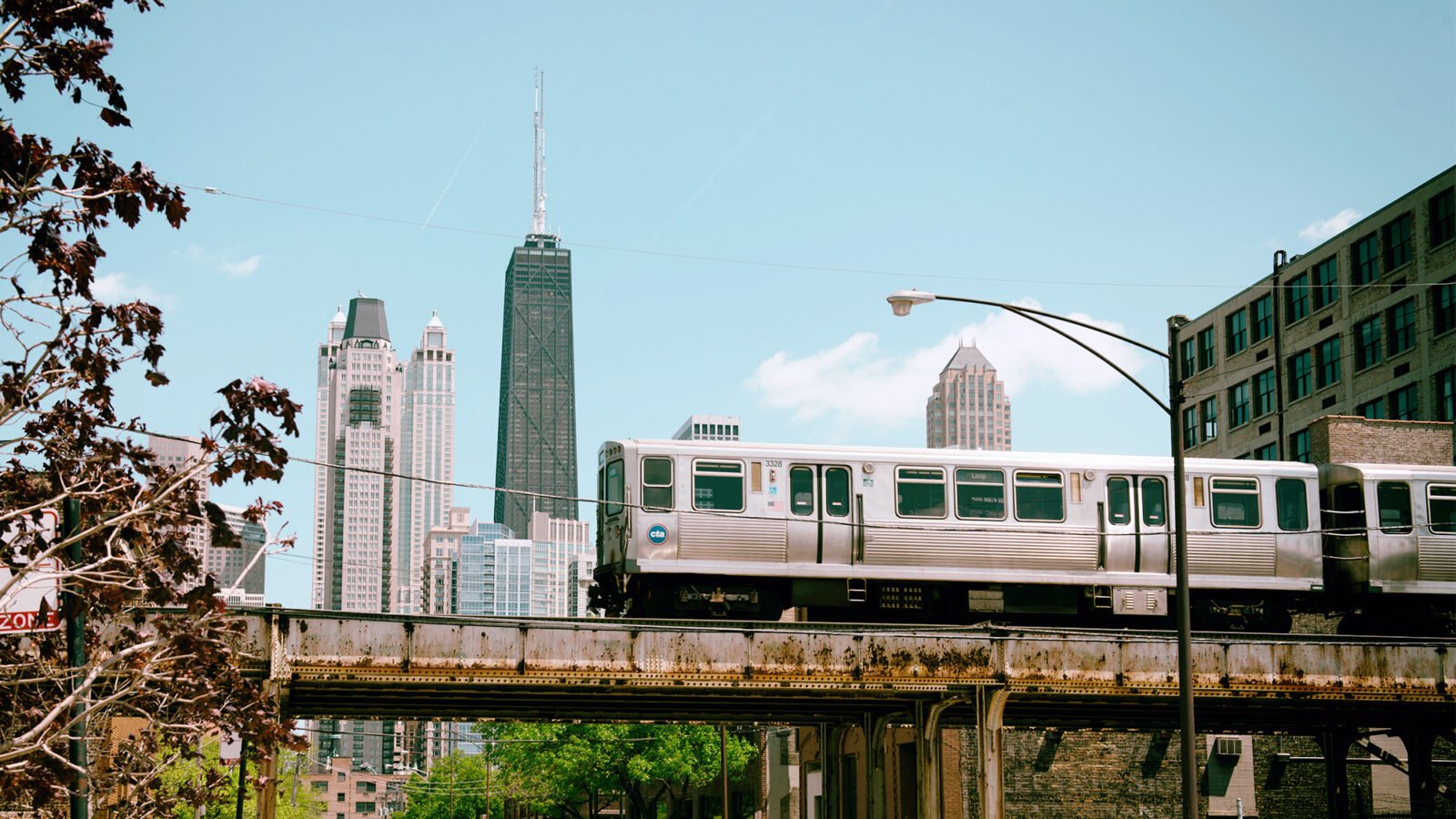 the cta train makes music of its own, squealing down the brown line