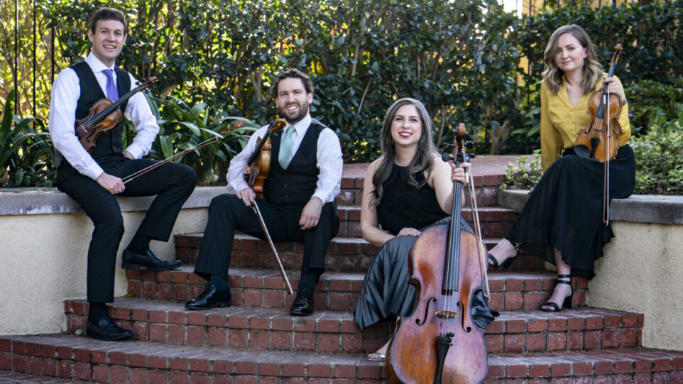 Kontras Quartet poses outside on a stairwell