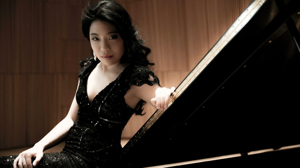 Joyce Yang poses dramatically with the piano