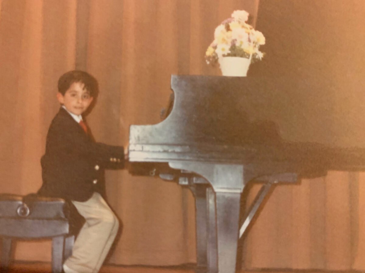 Ed O'Keefe as a child in recital at a piano