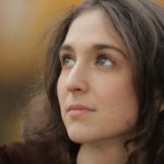 Woman softly lit looking into distance