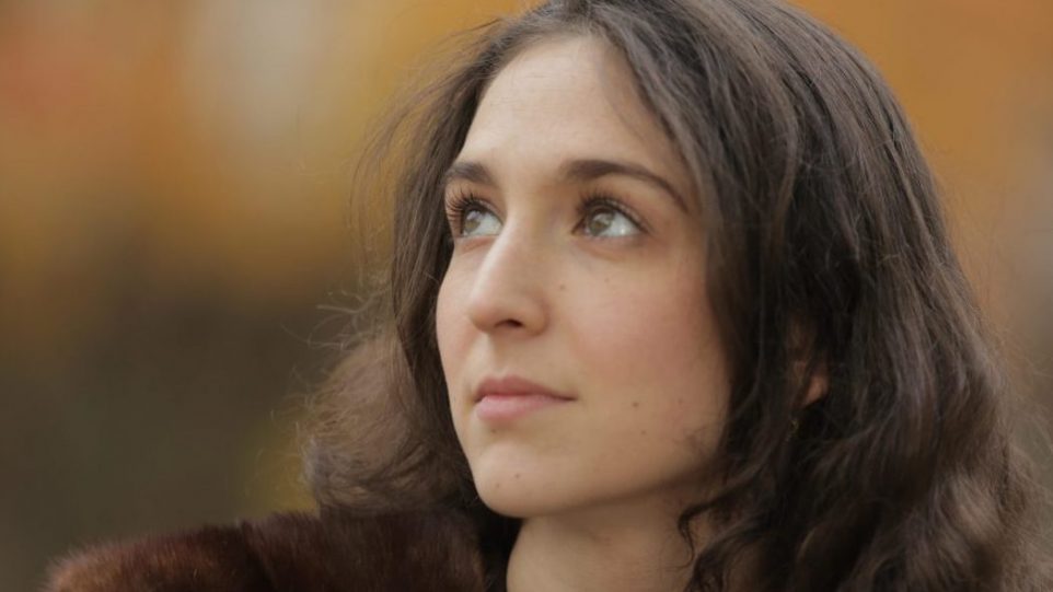 Woman softly lit looking into distance