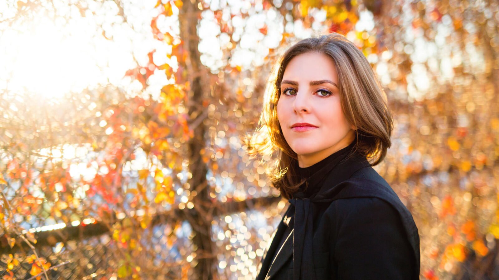 Portrait of Lidiya Yankovskaya in black suit, fall landscape background