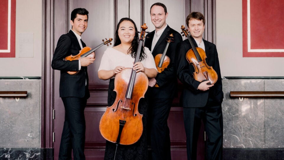 The Calidore String Quartet poses in an ornate room