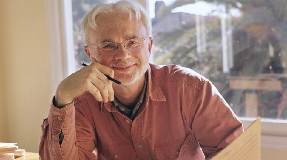 John Adams smiles from his workspace