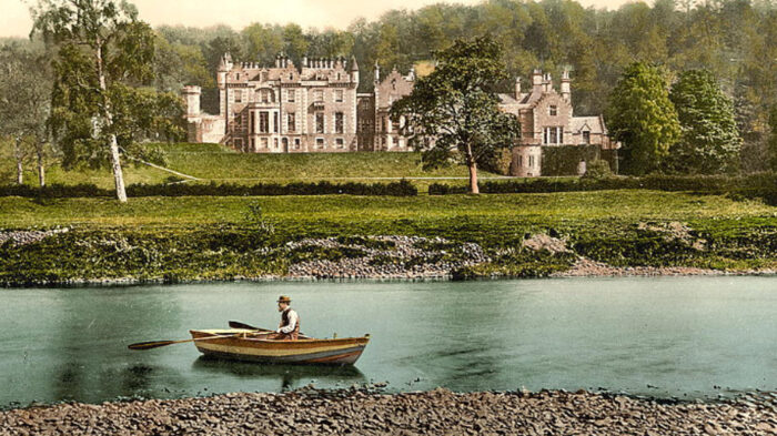 Image of man in boat with grand mansion in the background