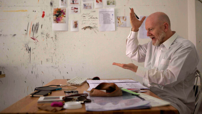 Brett Dean gestures passionately while at work composing