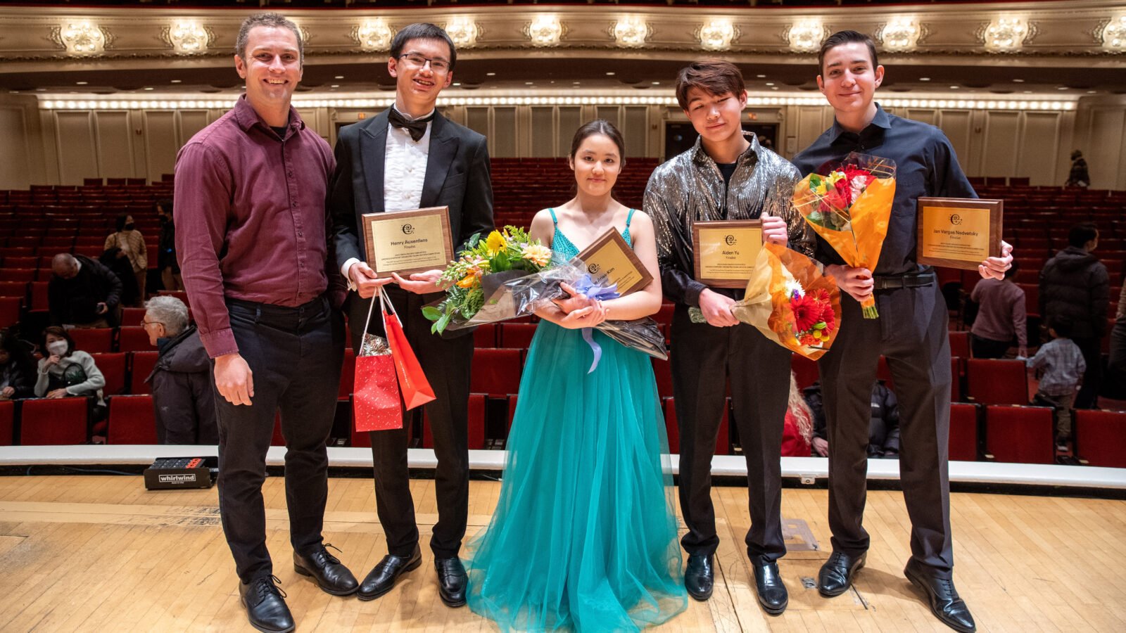 Onstage at Symphony Center (L-R): Robbie Ellis, Henry Auxenfans, Esme Arias-Kim, Aiden Yu, and Jan Vargas Nedvetsky