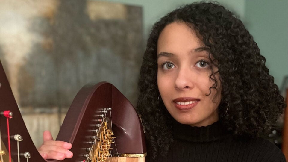 Miriam Kessler poses with a harp