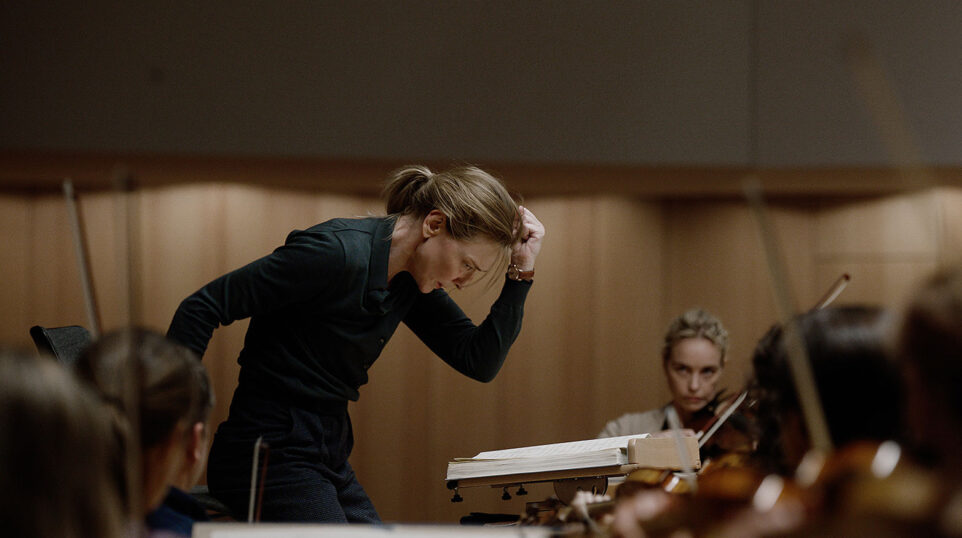 Still from TÁR (2022): Tár rehearses music newly admitted orchestra cellist Olga Metkina