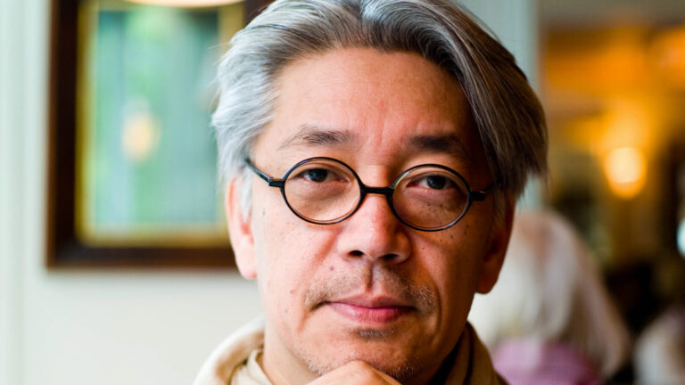 Ryuichi Sakamoto gazes pensively at the camera