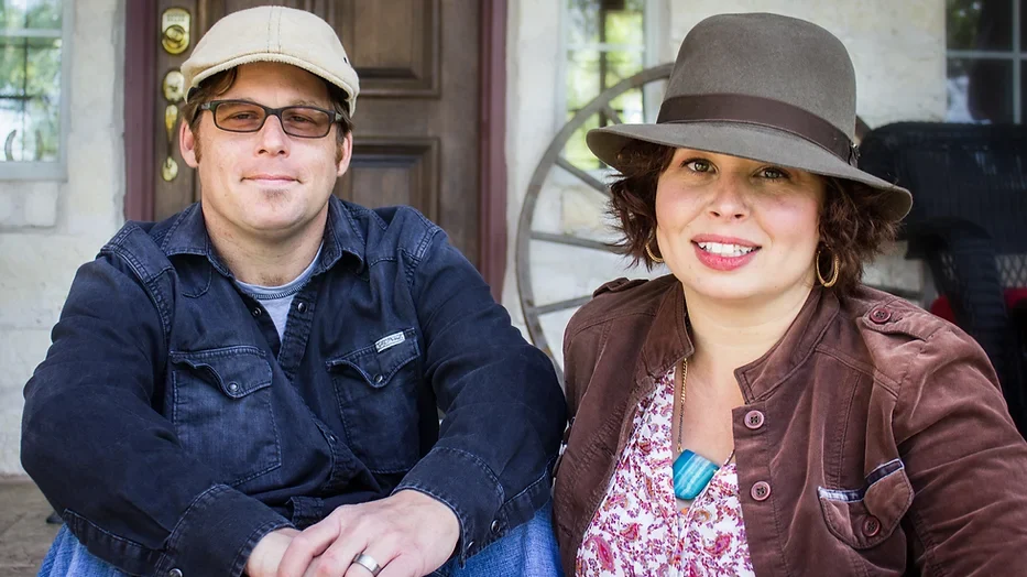 man wearing glasses and a snap brim hat, woman in sun hat