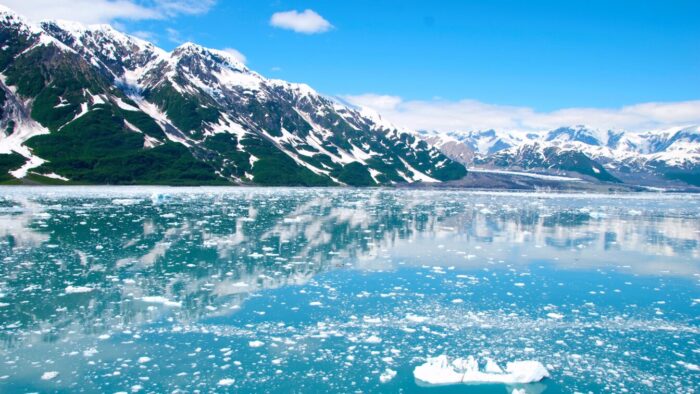 blue sky, glacier and blue water with ice floes