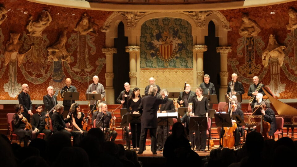 The instrumental ensemble Le Concert des Nations being conducted by Jordi Savall in concert in the ornate Palau de la Música Catalana.