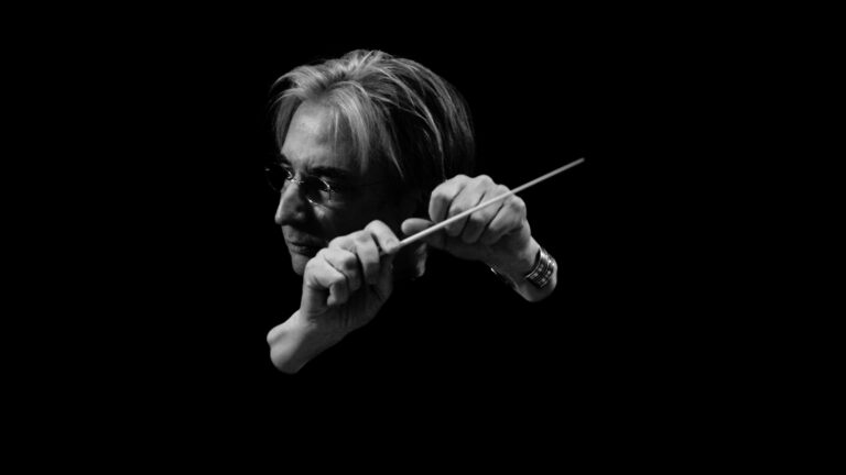 Black and white photo of Michael Tilson Thomas conducting