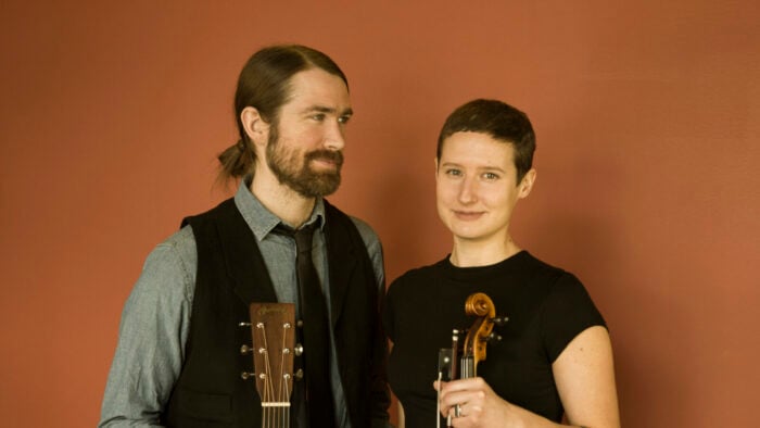 man and woman with guitar and fiddle