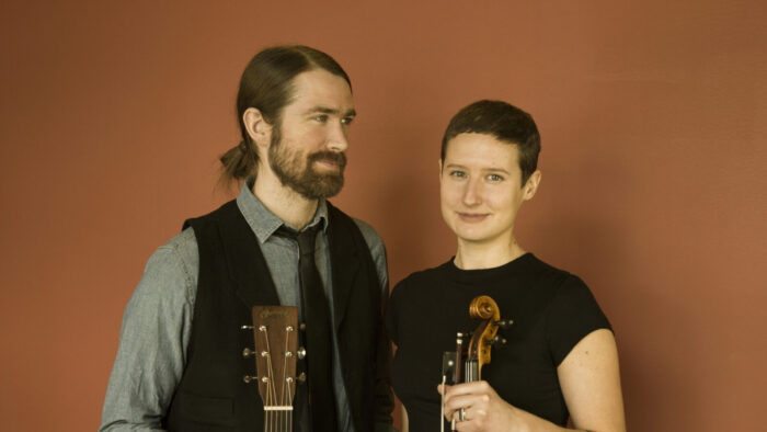 man and woman with guitar and fiddle