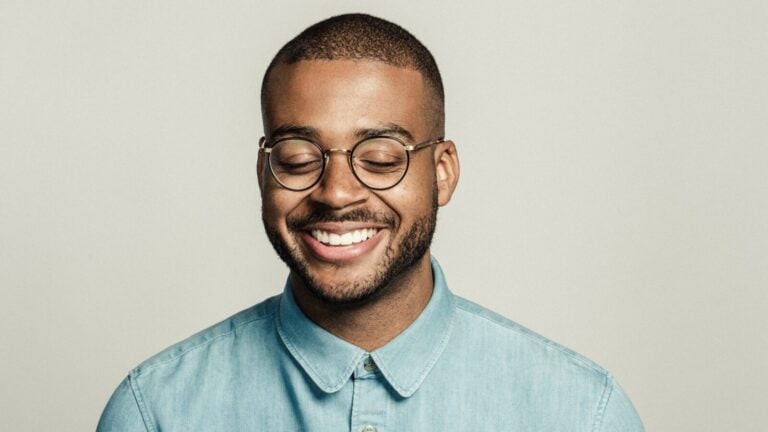 Kris Bowers smiles in a photo studio