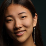 Portrait of pianist Clara Zhang, smiling at camera