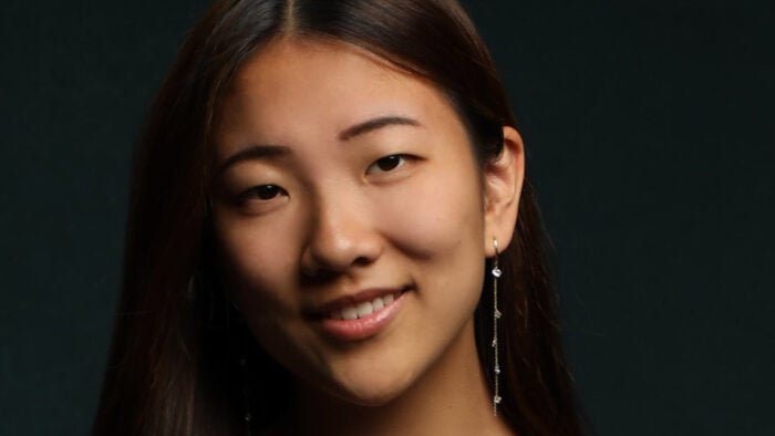 Portrait of pianist Clara Zhang, smiling at camera