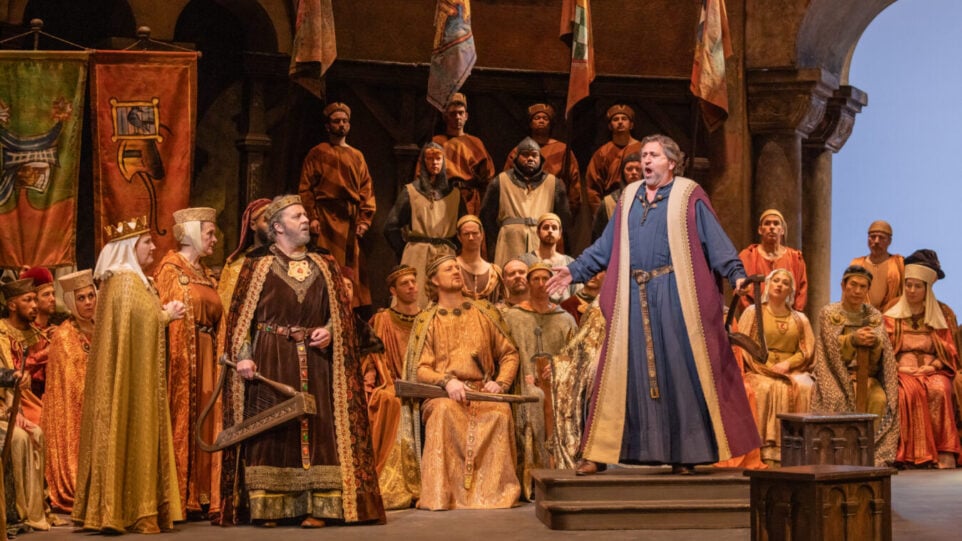 Christian Gerhaher as Wolfram and Andreas Schager as Tannhäuser surrounded by members of the chorus in Wartburg Castle, 13th century costume.