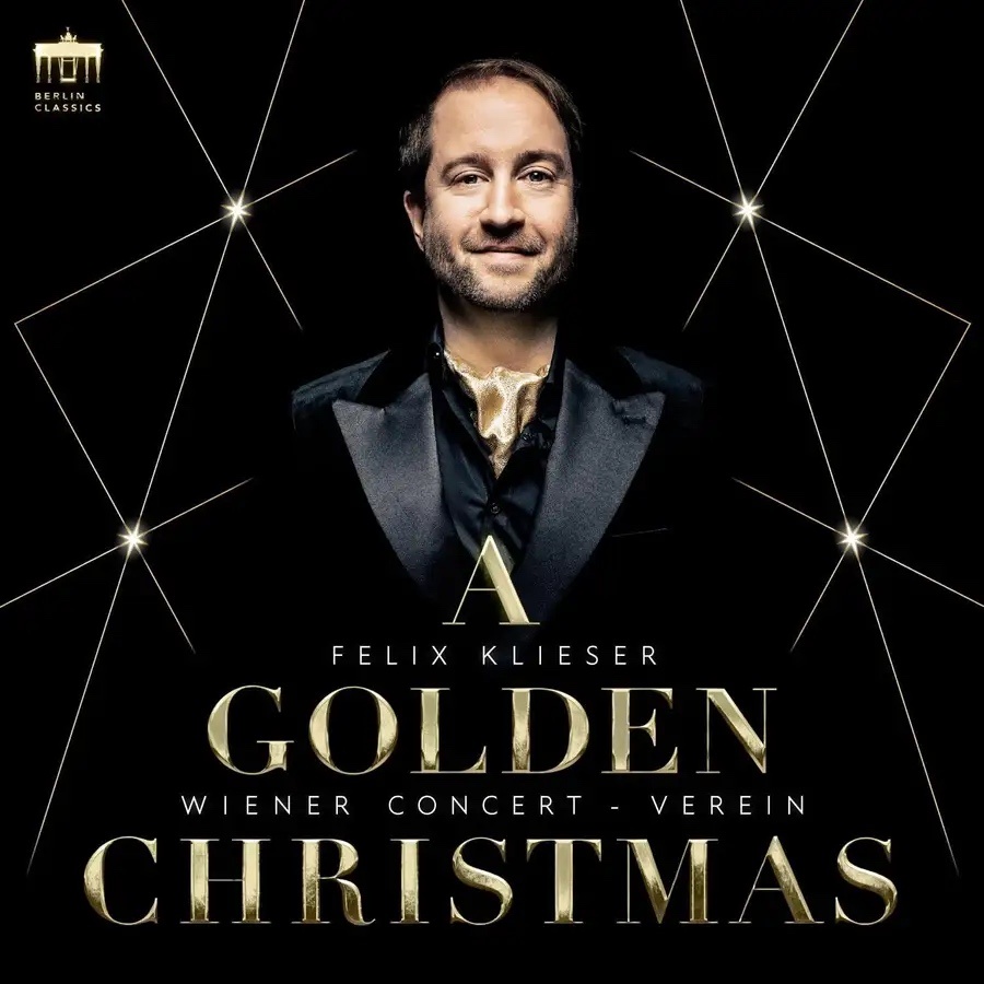 Album cover for 'A Golden Christmas', showing artist Felix Klieser dressed in black in front of a black backdrop with large gold text of the album title