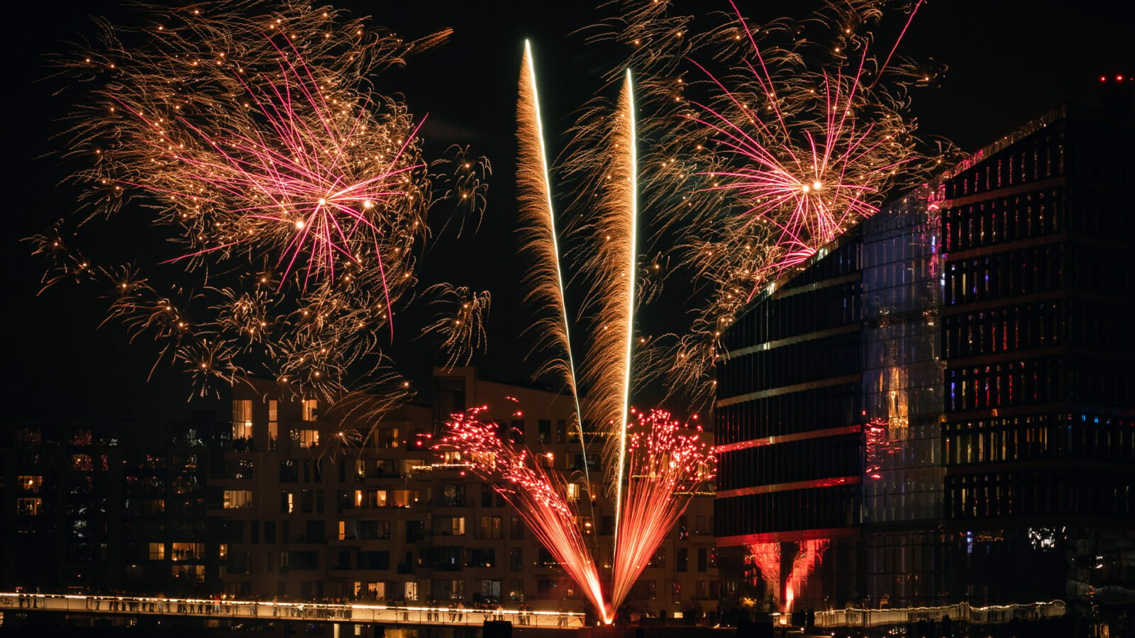 fireworks light up modern glass buildings in the Danish capital, Copenhagen