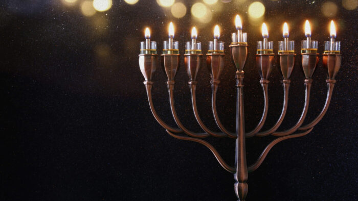 a lit menorah shines