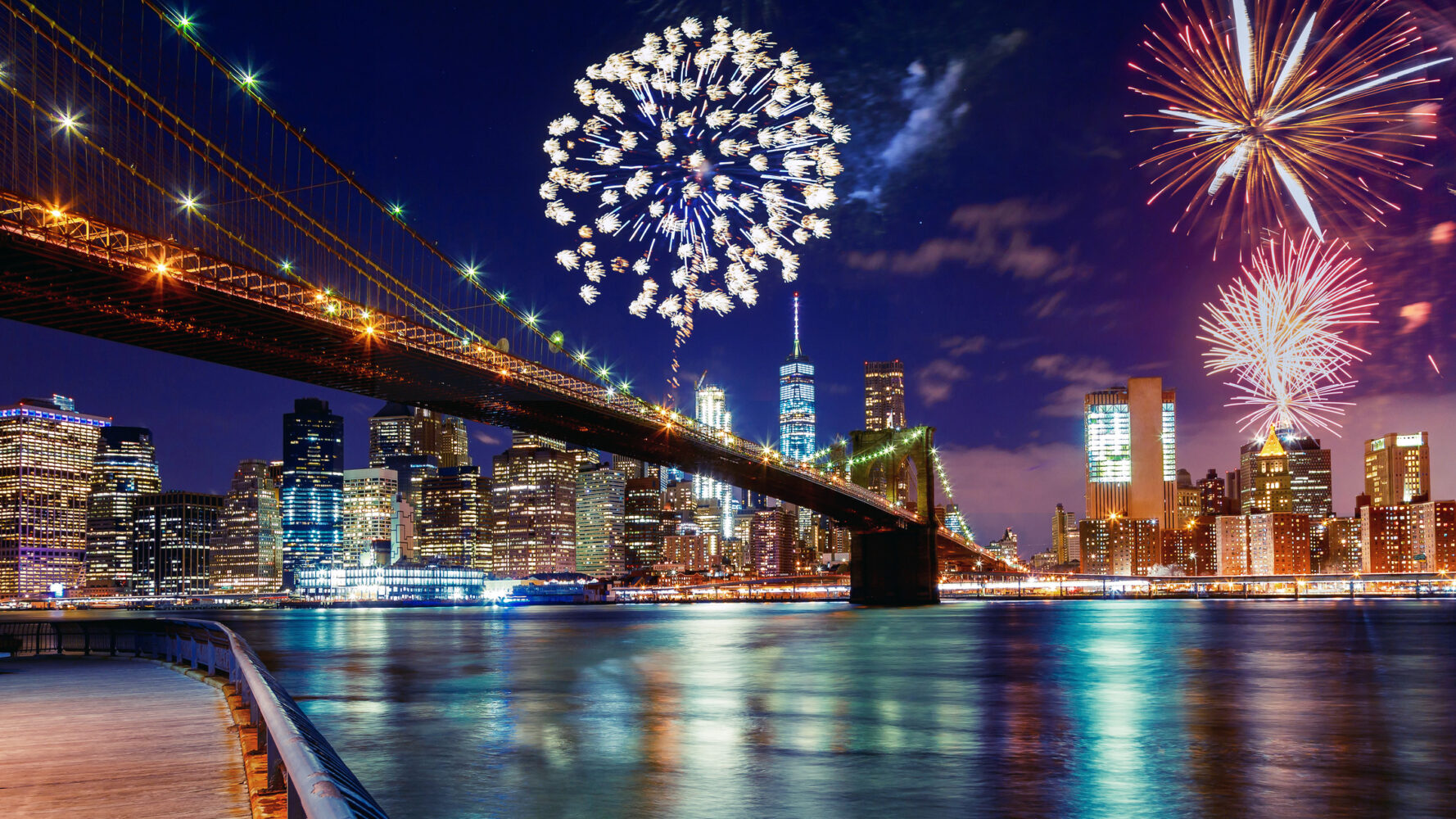 fireworks pepper the nighttime skyline of Manhattan