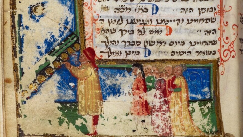 Detail of a framed marginal illustration of a man lighting the Hanukkah lamp with a congregation behind him