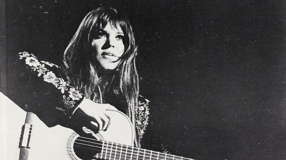 black and white photo of woman playing guitar