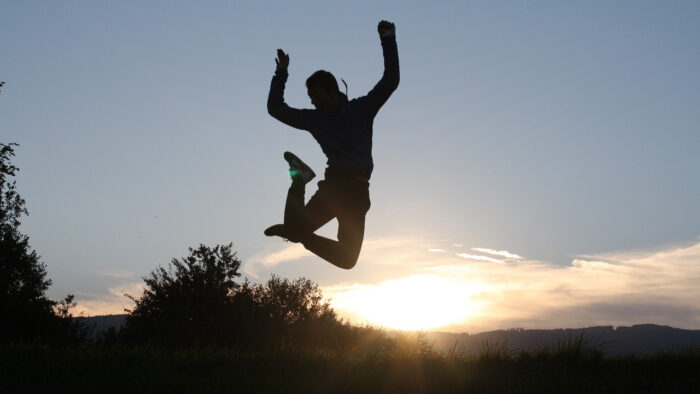 man leaping at sunset