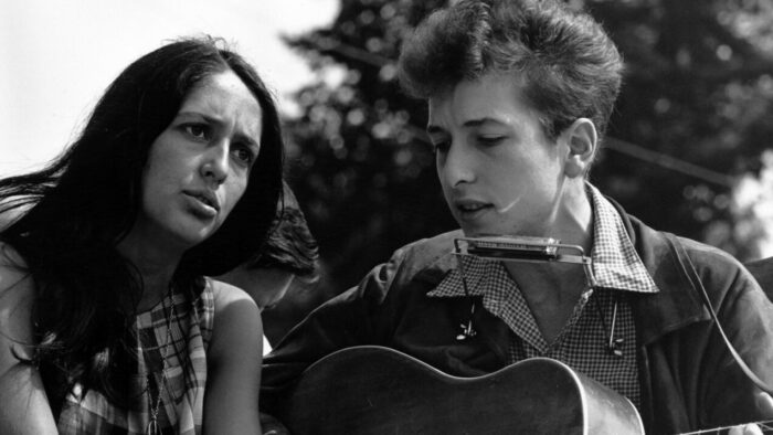 woman and man sing and play guitars