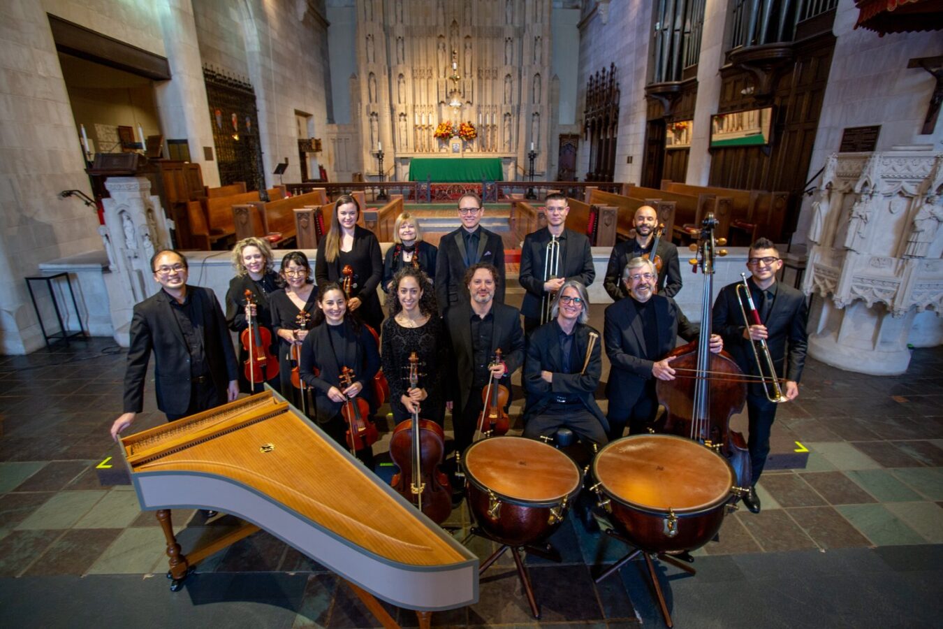 Ensemble Bella Voce Sinfonia poses in St. Luke’s Episcopal Church with their instruments.