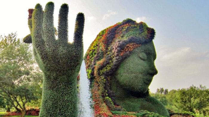 topiary animals, mother natures head and hand in a pool