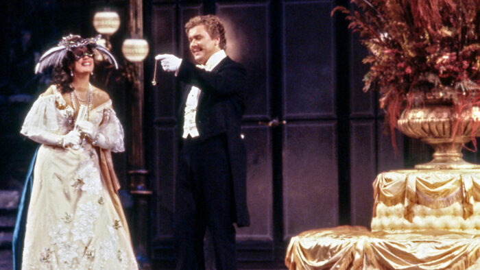 Kiri Te Kanawa and Håkan Hagegård share a gleeful moment onstage in formal period costume in 'Die Fledermaus'