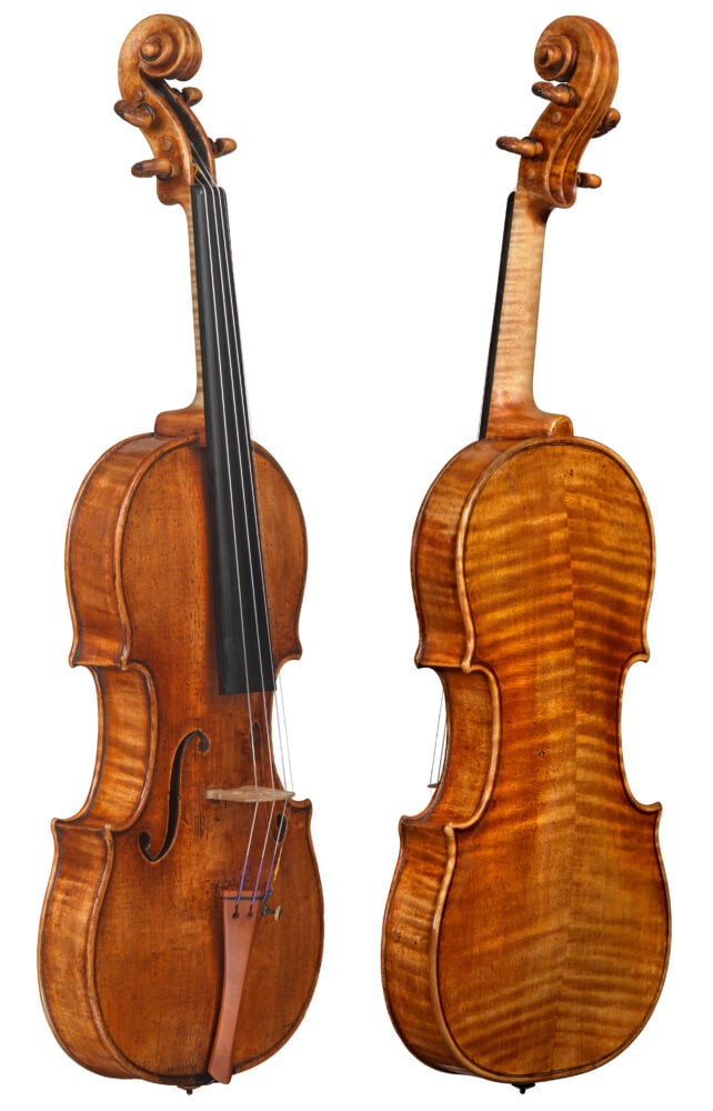 A photo of an old Stradivarius violin from 1742. It is a light orange brown in color with a tinge of red. The back of the violin has stripes running from the left side of the instrument to the right side, that meet in the middle, creating a very slight pyramid shape. 