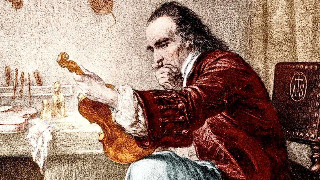 A painting of Antonio Stradivarius at his violin workshop. He is a white man with black hair, wearing a long red jacket and loose light blue pants. His chin is in his hand; he is propping up a violin on one knee and studying it thoughtfully.