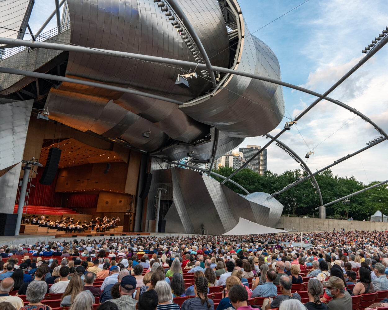 the GRant Park Orchestra performs on the striking Pritzker Pavilion stage to a full audience