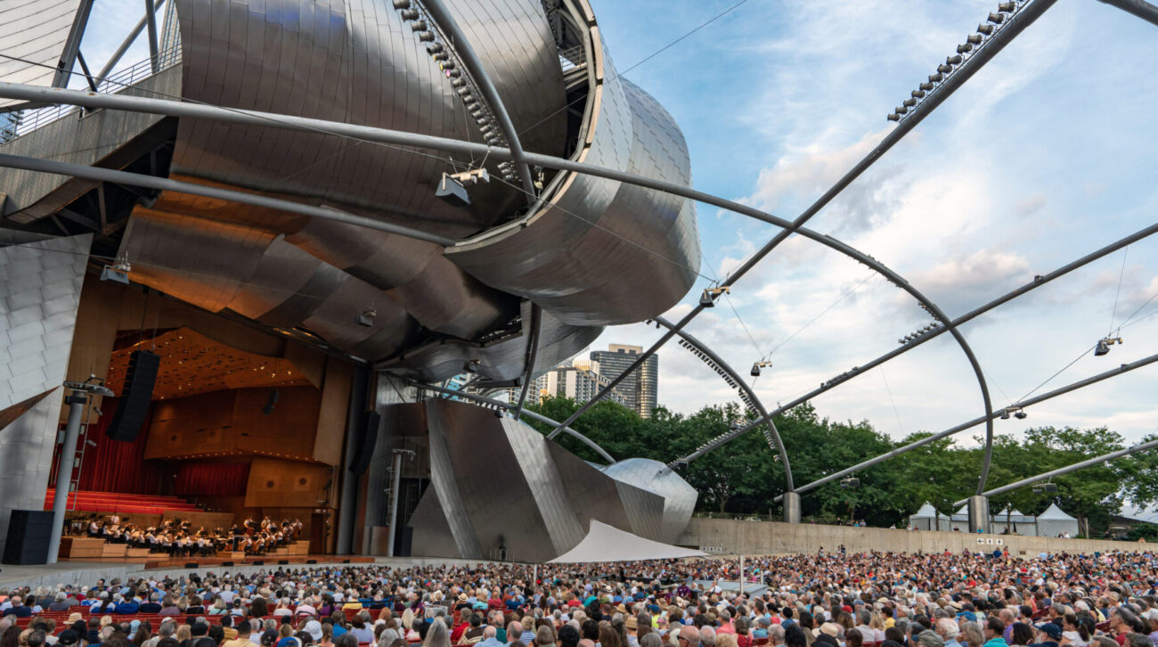 the GRant Park Orchestra performs on the striking Pritzker Pavilion stage to a full audience