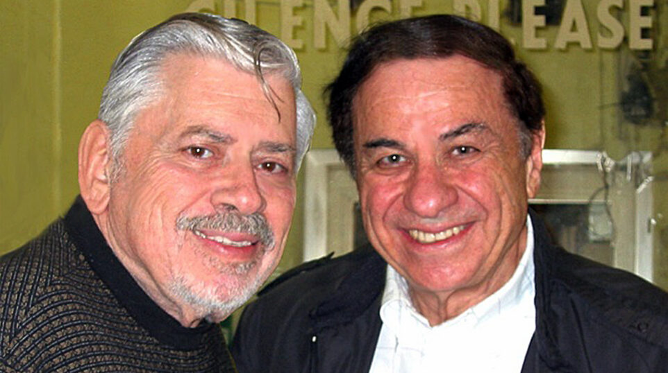 Two men smile
