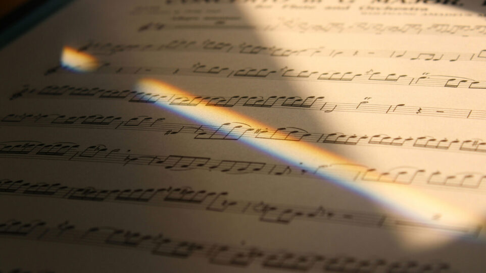 Sheet music with a diagonal glare of sunlight across