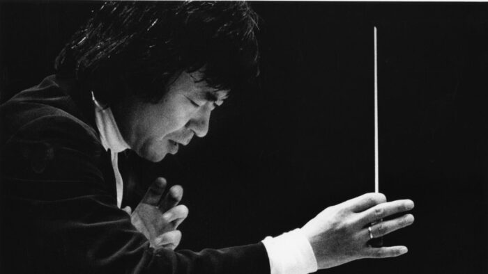 Focused man conducting in tuxedo