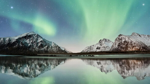Northern Lights and Mountains reflecting off a body of water