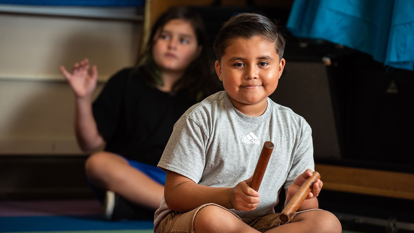 Boy playing rhythm sticks