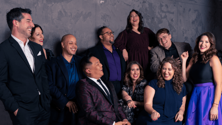 Candid portrait of ten members of Chicago a cappella, laughing.