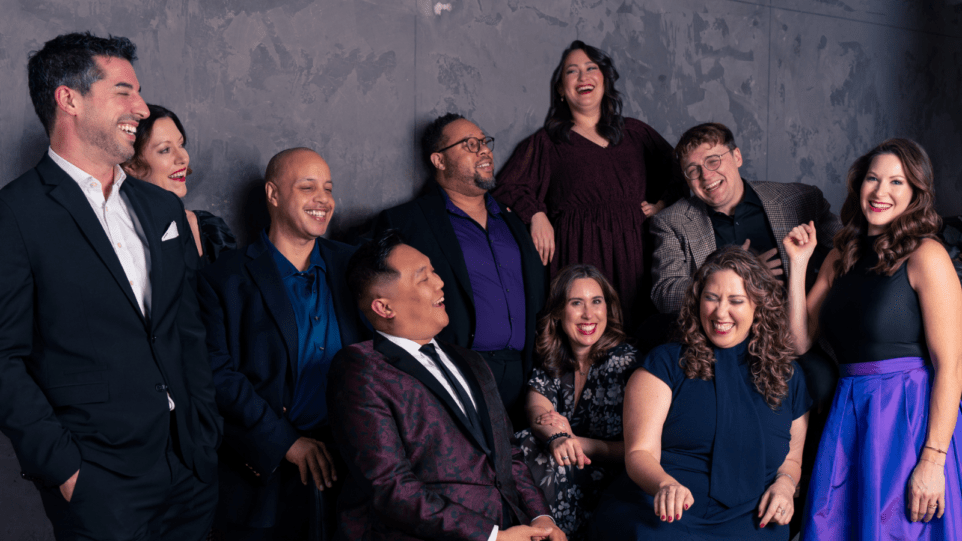 Candid portrait of ten members of Chicago a cappella, laughing.
